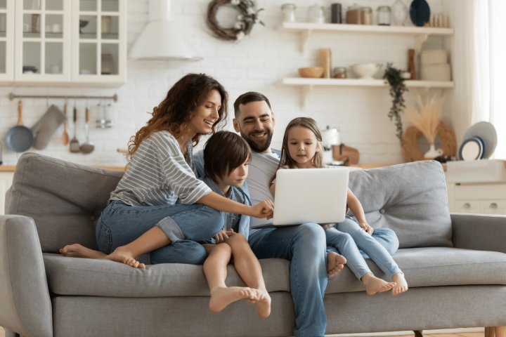 Happy family looking at a laptop